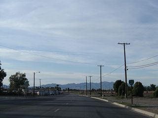 What was the first shield for Business Loop I-40 stood along Broadway Street at Desnok Street, next to the BNSF Needles Rail Yard.