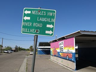 Removed when the intersection of Broadway Street and Needles Highway was upgraded with traffic lights, this small guide sign referenced Laughlin, Nevada for Arizona State Route 95 north.