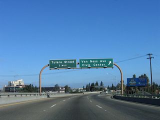 Northbound California 41 (Yosemite Freeway) reaches Exit 126B, Van Ness Avenue and Ventura Street. Use Van Ness Avenue north to Ventura Street east/west and to downtown Fresno including the Civic Center. This section of California 41 viaduct was built between 1966 and 1969. The next exit is Exit 127, Tulare Street.