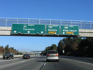 The right two lanes connect to California 180 east and west, while the left three lanes continue north on California 41 north to Yosemite National Park. California 180 travels east to Kings Canyon National Park (Exit 128A) and west to Mendota (Exit 128B). The control city for northbound California 41 (Eisenhower / Yosemite Freeway) is now Yosemite National Park.