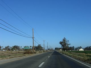Lacey Boulevard crosses agricultural areas east from SR 41 before entering the commercialized west side of Hanford.