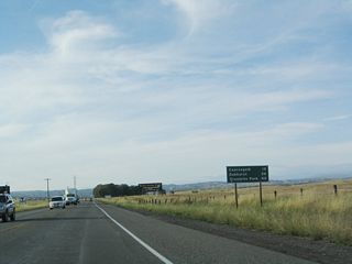 This mileage sign, posted after the California 145 intersection, provides the distance to Coarsegold (19 miles), Oakhurst (26 miles), and Yosemite National Park (42 miles) via California 41 north.