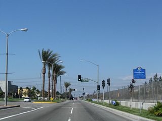 A large big box retail complex lines the west side of Alameda Street north of Artersia Boulevard in Compton.