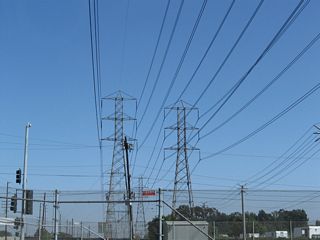 A set of Southern California Edison power lines cross over Alameda Street and the adjacent Alameda Corridor / Union Pacific Railroad by Greenleaf Boulevard.