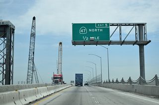 SR 47-103 (Terminal Island Freeway) north leave Long Beach and enter the city of Los Angeles after departing from Terminal Island. The adjacent Ports of Los Angeles and Long Beach feature massive container yards with towering cranes designed to lift cargo from ships and transfer them to holding areas until trucks or rail can transport the freight to the appropriate market.