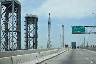 The Henry Ford Bridge, a lift bridge along the Alameda Corridor, spans Cerritos Channel along the west side of the Commodore Schuyler F. Heim Bridge. The Alameda Corridor carries freight from the Ports of Los Angeles and Long Beach north to large railyards near Downtown Los Angeles.