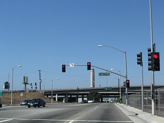 A flyover ramp links Alameda Street with SR 91 (Gardena Freeway) eastbound to Anaheim and Riverside directly.
