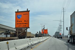 Interstate 710 ascends across the East Channel over the Long Beach International Gateway bridge to the Queen Mary, Aquarium of the Pacific, and Long Beach Cruise Ship Terminal.