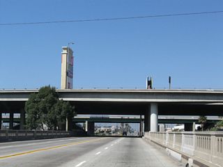Alameda Street spans Compton Creek below the elevated lanes of the Gardena Freeway.