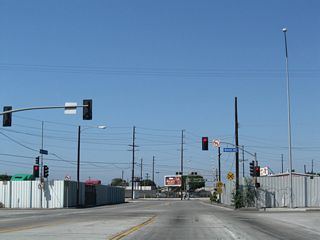 North of Anaheim Street, Henry Ford Avenue continues by additional industrial development with large storage areas and cargo businesses to the signalize at Denni Street.