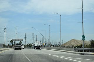 SR 47 (Henry Ford Avenue) proceeds north from Pier A Avenue across Dominguez Channel. The channel flows south into the Consolidated Ship Channel, which opens into the East Basin by Terminal Island.