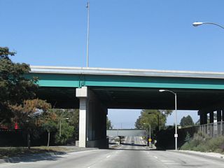 Interstate 405 (San Diego Freeway) spans Alameda Street across a high viaduct paralleling 233rd Street to the north.