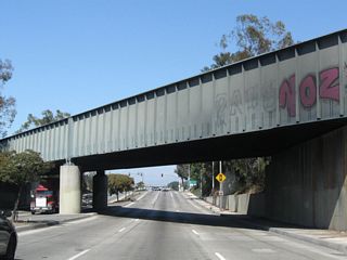 A railroad bridge to the Union Pacific Railroad Intermodel Container Transfer Facility passes over Alameda Street north of I-405.