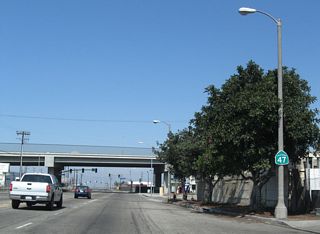 Although signed as a state route, Alameda Street is not currently maintained by Caltrans. This reassurance shield precedes Mauretania Street and the grade separation of SR 1 (Pacific Coast Highway).