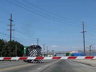 Another railroad line crosses Alameda Street at-grade by Robidoux Street. The locomotive in view was labeled as being part of the Pacific Harbor Line with low emissions.