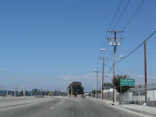 Santa Fe Avenue shifts westward to pass just east of SR 47 (Alameda Street). The northern section of the arterial branches northeast from a wye intersection with Alameda Street to industrial areas across Compton Creek.