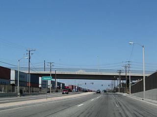 A viaduct takes Sepulveda Boulevard over Alameda Street east from between the Tesoro Carson Refinery and Los Angeles Refiner.