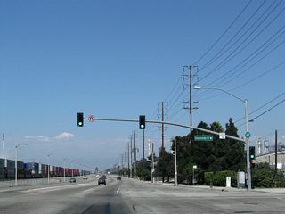 A four lane access road connects Alameda Street with Sepulveda Boulevard east to Willow Street and the north end of SR 103 (Terminal Island Freeway) or west to Torrance.