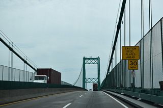 Statistically speaking, the Vincent Thomas bridge &quot;required 92,000 tons of Portland cement; 13,000 tons of lightweight concrete; 14,100 tons of steel; and 1,270 tons of suspension cable.&quot; (The bridge) is designed to withstand winds of 90 miles per hour, double that required by code. The overall length of the bridge is 6,050 feet, with a main suspension span of 1,500 feet and 500-foot spans on either side. The towers are 365 feet high.&quot;1