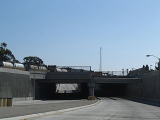 Beyond the Blue Line, SR 47 drops below grade to pass under the Alameda Corridor railway, which carries four mainline Union Pacific Railroad tracks.