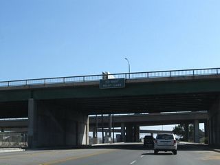 Passing under Artesia Boulevard, SR 47 (Alameda Street) advances south to the flyover ramp leading onto SR 91 eastbound to Anaheim and Riverside.