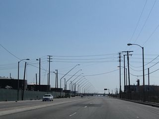 State Route 47 leaves Carson and enters the city of Los Angeles midway between Sepulveda Boulevard and Pacific Coast Highway, around the point where the street light standards change and the LADWP power lines cross over Alameda Street.