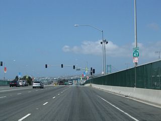Removed by 2014, an erroneous SR 47 north reassurance marker preceded the signalized intersection with Navy Way south. Navy Way south to Terminal Way connects SR 47 with Port of Los Angeles berths numbering in the 200s.