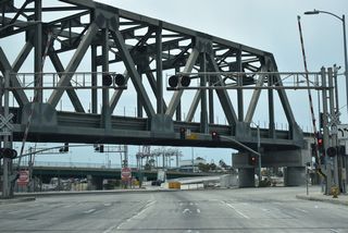 Henry Ford Avenue spurs south to Anchorage Road along the west side of the Alameda Corridor. Pier A Way leads east to the adjacent oil refinery complex and Port oF Long Beach Pier A.