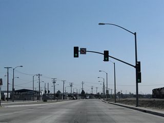 The northern section of Santa Fe Avenue converges with Alameda Street at this traffic signal. No turns are permitted here from southbound Alameda Street.