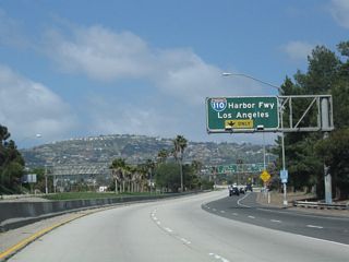 An auxiliary lane opens along SR 47 west for the unnumbered exit onto Interstate 110 (Harbor Freeway) north to Downtown Los Angeles.