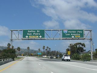 Two lanes continue across a flyover above I-110 onto Summerland Avenue west ahead of Gaffey Street.