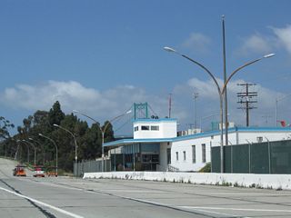 The Vincent Thomas Bridge toll plaza preceded the east bridge approach. The toll authority building on the north side was repurposed as the Caltrans Terminal Island Maintenance Station.