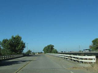 Between the Interstate 5-Interstate 205 split and California 120, Manthey Road (which runs parallel to Interstate 5 through Lathrop) is the old alignment of U.S. 50 (Lincoln Highway). This series of pictures follows Manthey Road as it crosses two sets of bridges. The first is a 1932 bridge (note date stamp) that crosses the Paradise Cut. The second, much more substantial bridge, carries Manthey Road over the San Joaquin River.