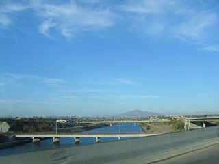 Two lanes connect Interstate 5 (Montgomery Freeway) south with California 54 (Filipino-American Highway) east. Below the interchange, the Sweetwater River courses between the two directions of California 54 freeway.