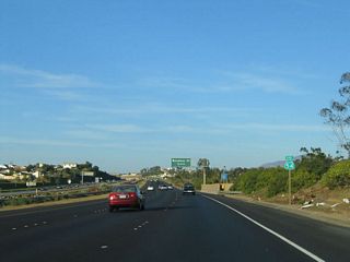 A California 54 east reassurance shield is posted after the Reo Drive on-ramp and prior to the Woodman Street interchange.