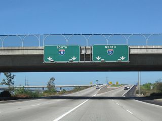 Passing under the U.S. 101 bridge, westbound California 54 prepares to split. The left two lanes connect to Interstate 5 (Montgomery Freeway) south to San Ysidro and Imperial Beach; the righ two lanes connect to Interstate 5 (Montgomery Freeway) north to downtown San Diego.