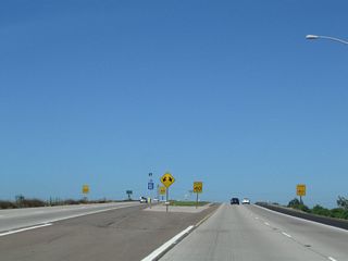 Westbound California 54 splits: stay left for Exit 1A, Interstate 5 (Montgomery Freeway) south to San Ysidro and Imperial Beach or stay right for Exit 1B, Interstate 5 (Montgomery Freeway) north to downtown San Diego. No end shield is posted here.