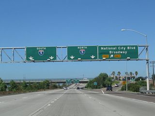 Westbound California 54 reaches Exit 1 C for National City Boulevard (Historic U.S. 101) north and Broadway south. U.S. 101 predates I-5 as the main coastal north-south highway through San Diego. Beginning at the San Ysidro international border crossing with Mexico, U.S. 101 followed Beyer Boulevard, Broadway, National City Boulevard, Civic Center Drive, Harbor Drive, Pacific Highway, Mission Bay Drive, Gilman Drive, North Torrey Pines Road, and Camino del Mar from San Ysidro north to Del Mar.
