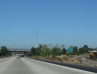 The Highland Avenue and Fourth Avenue interchange is a standard diamond, but the Sweetwater River through the median of the freeway makes it an extra wide interchange.