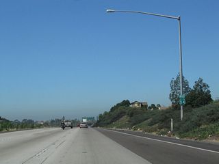 A California 54 west reassurance shield is posted after the Woodman Road interchange.
