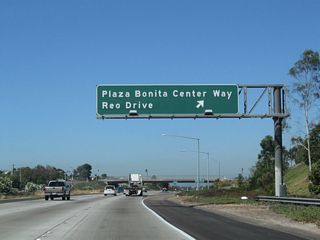Westbound California 54 (Filipino-American Highway) reaches Exit 3, Plaza Bonita Center Way south and Reo Drive north. This is the first of several interchanges to serve the city of National City.