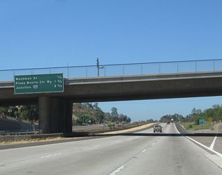 This mileage sign along California 54 west provides the distance to the next three exits: Exit 4, Woodman Street; Exit 3, Plaza Bonita Center Way and Reo Drive; and Exit 2, Interstate 805 (Jacob Dekema [Inland] Freeway).