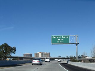 After transitioning from Interstate 5/Local Bypass north onto eastbound California 56, the first exit along eastbound is Carmel Creek Road (Exit 1A).