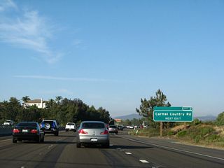 A roadside sign along California 56 (Ted Williams Freeway) east for Exit 2, Carmel Country Road is posted shortly thereafter. Like Carmel Creek Road, Carmel Country Road serves the community of Carmel Valley.