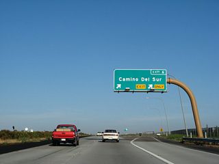 Eastbound California 56 (Ted Williams Freeway) reaches Exit 6, Camino del Sur. Use this exit to the community of Torrey Highlands and Black Mountain Ranch. Westview High School is located north of the freeway along Camino del Sur. To the south, future plans call for the extension of Camino del Sur toward Park Village, but the presence of vernal pools may prevent development of the area for years to come. As such, the timing of the roadway extension is in doubt.