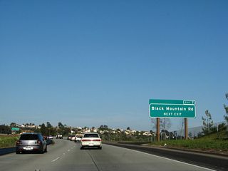 Another roadside exit number sign is posted for the Black Mountain Road interchange (Exit 7).