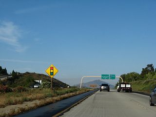 A signal ahead sign is posted soon thereafter. All traffic should prepare to stop.