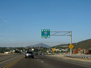 The freeway ends. The next right turn connects to Interstate 15 south. Continue straight ahead for Ted Williams Parkway and Interstate 15 north.