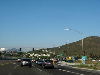 At this traffic signal, eastbound California 56 connects to Interstate 15 south. Traffic merges onto California 56 from Interstate 15 south at this traffic signal as well.