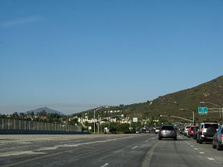 An eight-lane bridge carries Ted Williams Parkway over Interstate 15. The bridge was expanded as part of the Interstate 15 Managed Lanes project in 2007.